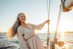 Radiant Older Woman On A Yacht At Dusk Photo